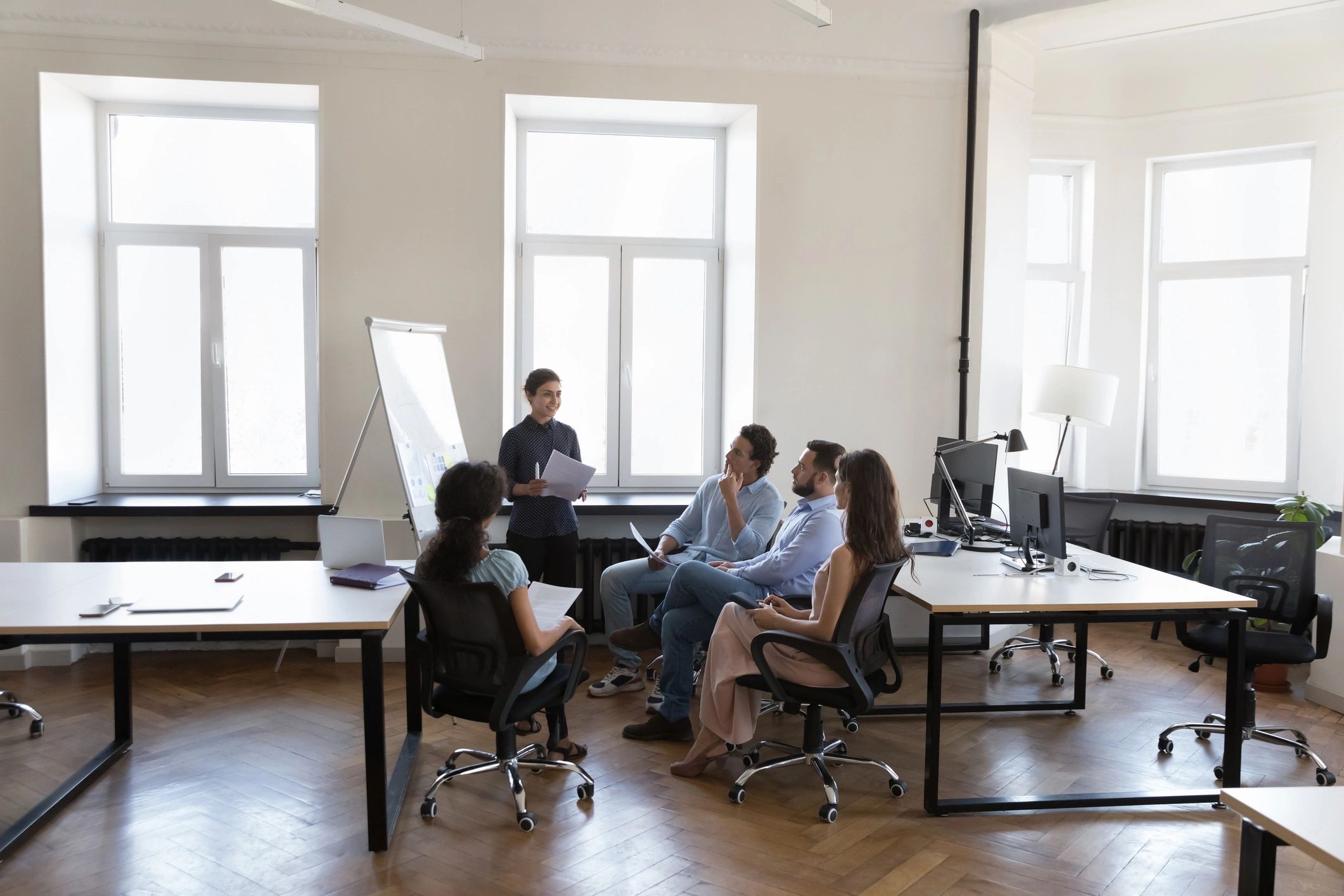 Corporate trainer presenting to employees in a workshop