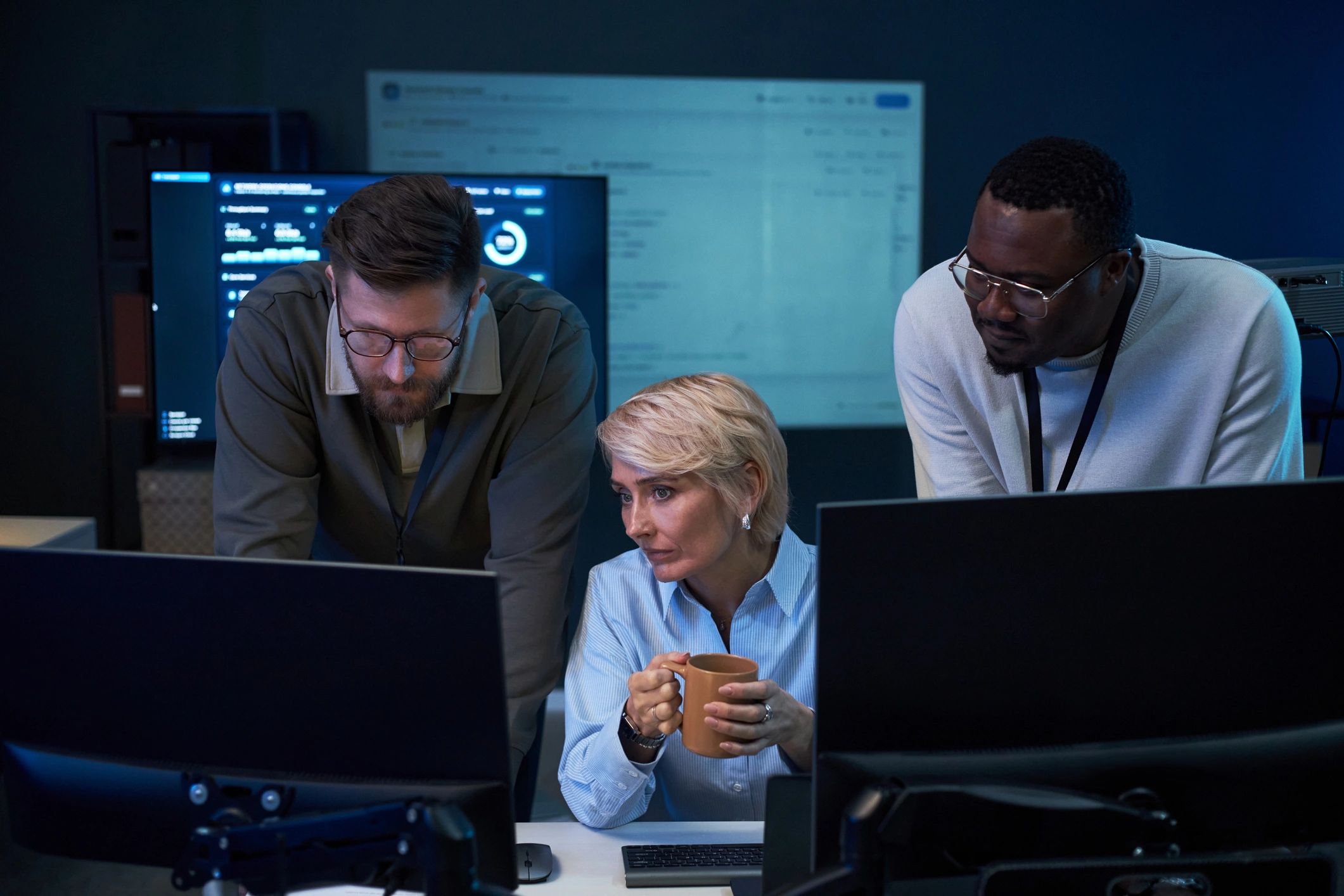 IT professionals monitoring data and systems